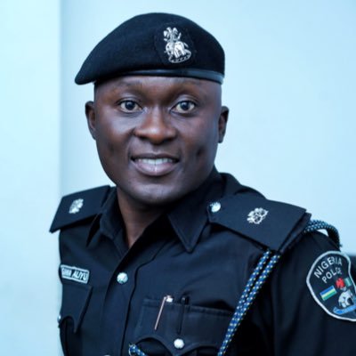 Nigerian Police Officer reminding the public of the driver's license law in Nigeria